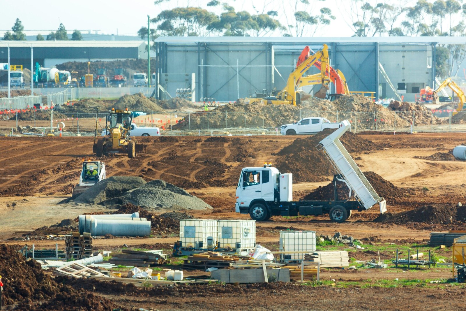 a construction site with trucks and construction equipment